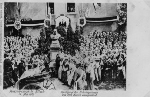 Le monument érigé en l'honneur de l'Empereur Guillaume Ier, grand-père de Guillaume II, est richement fleuri et la nombreuse foule est venue saluer son Empereur sur la Kaiserplatz ou place Sainte-Jeanne-d'Arc, au pied de l'église catholique Sainte-Catherine.