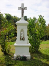 Une croix de chemin est érigée dans la rue de Guisberg et présente une statue de la Sainte Vierge dans une niche aménagée dans le fût.