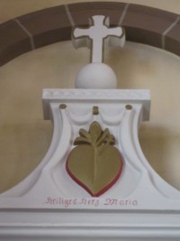 L'autel est surmonté d'un cœur transpercé accompagné de l'invocation : « Heiliges Herz Maria ».