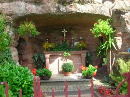 La réplique de la grotte abrite un autel en grès rose. La réplique de la grotte abrite un autel en grès rose.